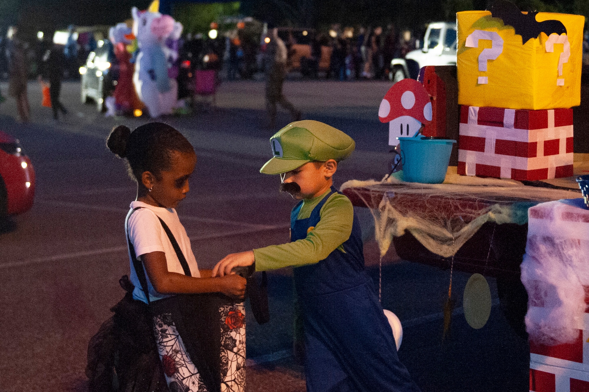 A participant receives candy during Trunk or Treat Oct. 25, 2019, at Moody Air Force Base, Ga. Participants, dressed in costumes, received candy from volunteers, who decorated their trunks. (U.S. Air Force photo by Airman 1st Class Jasmine M. Barnes)
