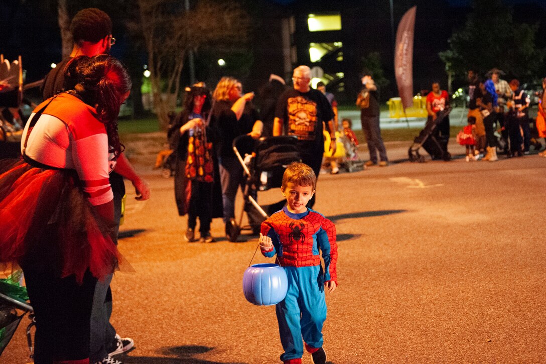 A participant walks to the next trunk during Trunk or Treat Oct. 25, 2019, at Moody Air Force Base, Ga. Participants, dressed in costumes, received candy from volunteers, who decorated their trunks. (U.S. Air Force photo by Airman 1st Class Jasmine M. Barnes)