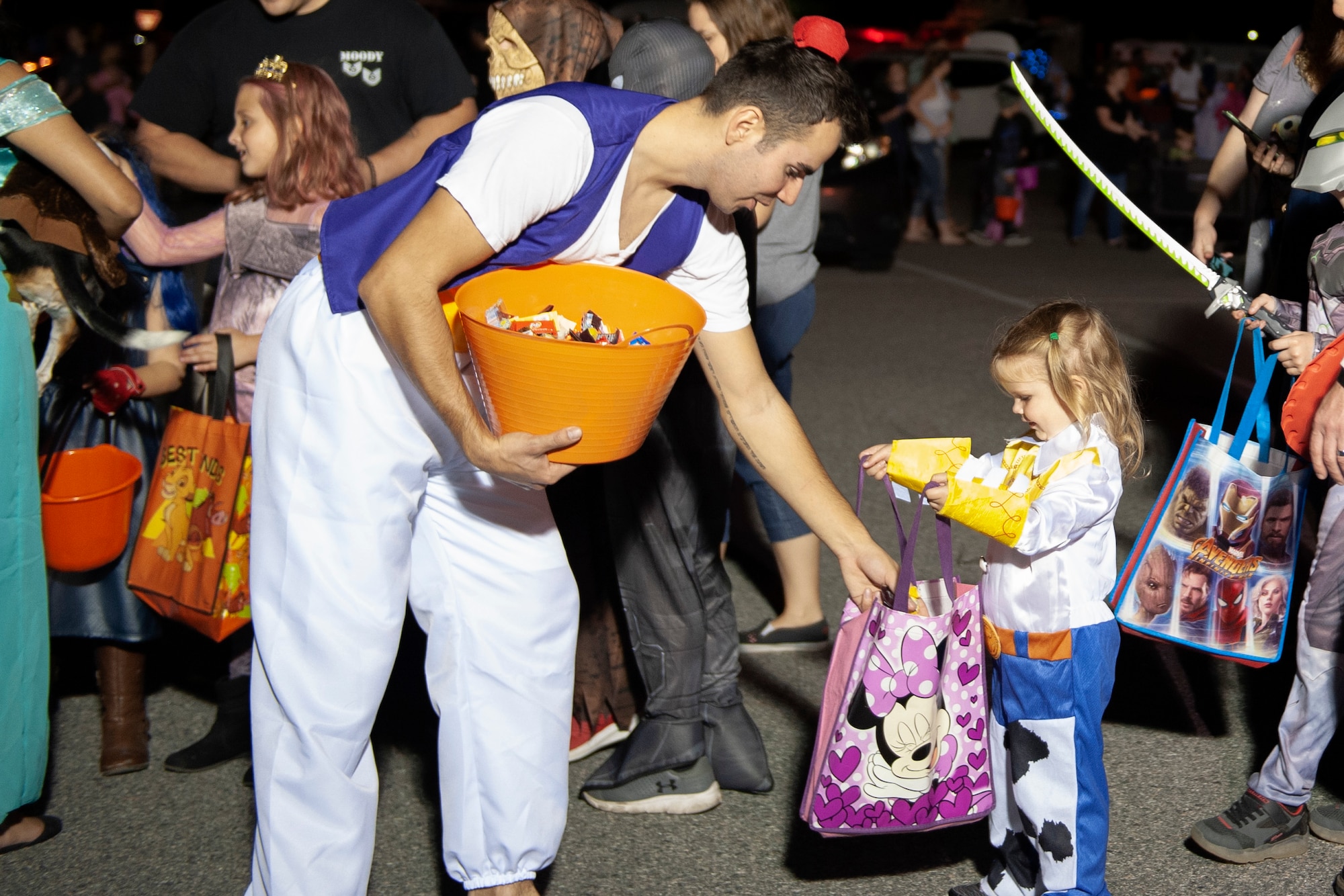 A Trunk or Treat volunteer hands out candy Oct. 25, 2019, at Moody Air Force Base, Ga. Participants, dressed in costumes, received candy from volunteers, who decorated their trunks. (U.S. Air Force photo by Airman 1st Class Jasmine M. Barnes)