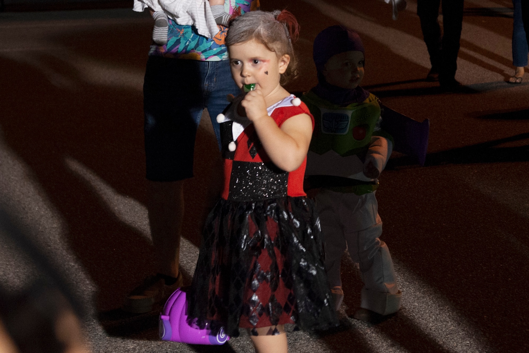 A participant eats candy during Trunk or Treat Oct. 25, 2019, at Moody Air Force Base, Ga. Participants, dressed in costumes, received candy from volunteers, who decorated their trunks. (U.S. Air Force photo by Airman 1st Class Jasmine M. Barnes)
