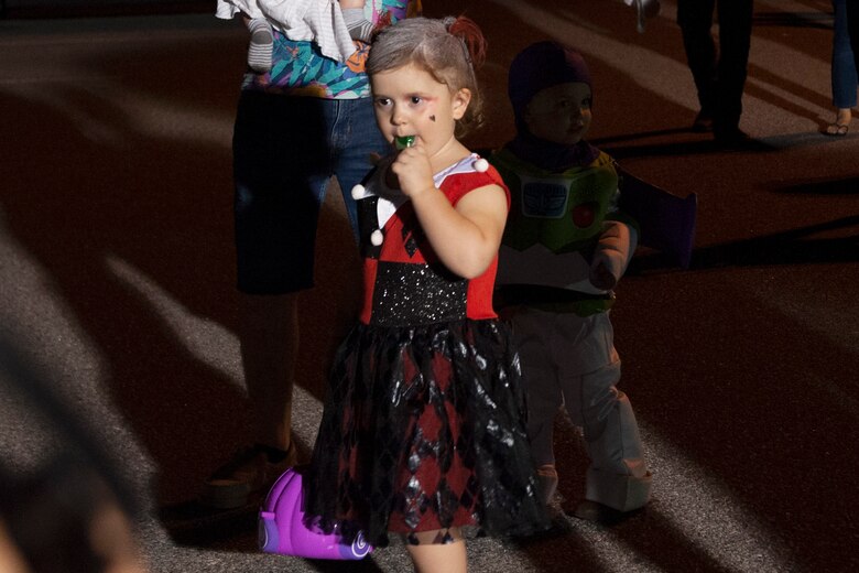 A participant eats candy during Trunk or Treat Oct. 25, 2019, at Moody Air Force Base, Ga. Participants, dressed in costumes, received candy from volunteers, who decorated their trunks. (U.S. Air Force photo by Airman 1st Class Jasmine M. Barnes)