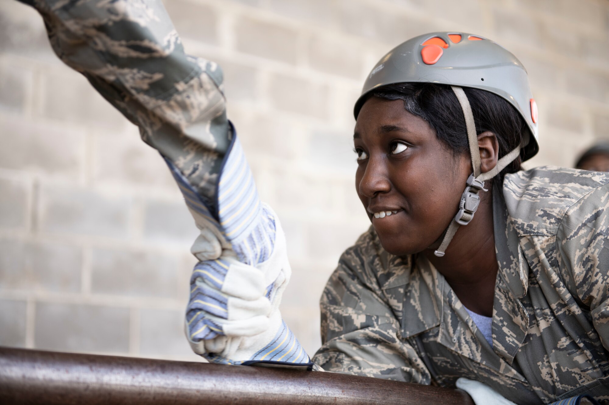 An Air Force Junior Reserve Officer Training Corps cadet from Robert E. Lee High School takes her teammates hand while balancing across an obstacle a part of the Officer Training School Leadership Reaction Course, Oct. 24, 2019, Maxwell Air Force Base, Alabama. The LRC is comprised of a series of obstacles that are designed to foster teamwork, communication and critical thinking. (U.S. Air Force photo by Senior Airman Alexa Culbert)