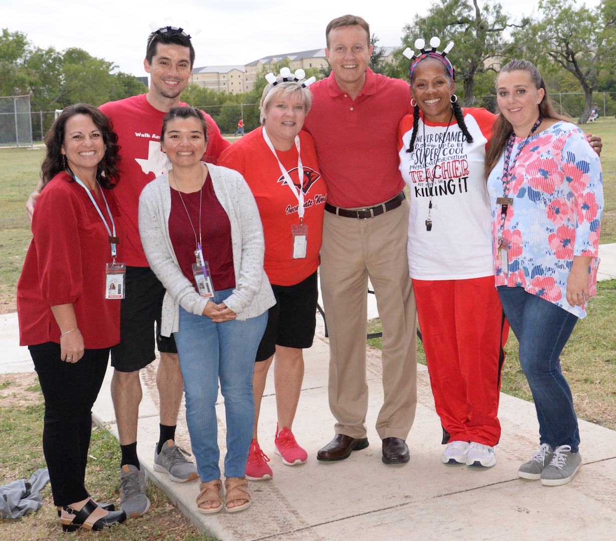 Fort Sam Houston Elementary School assistant principal Scott Stuller (center) and faculty members share the Red Ribbon Week support in wearing red to take a stand against bullies and drugs. Red Ribbon Week is a nationwide drug and bully awareness campaign from Oct. 23-31.