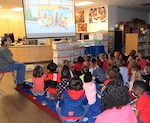 Pre-kindergarten and first-grade students kick off Red Ribbon Week wearing their red shirts while watching an animated video at the Fort Sam Houston Elementary Library Oct. 28.