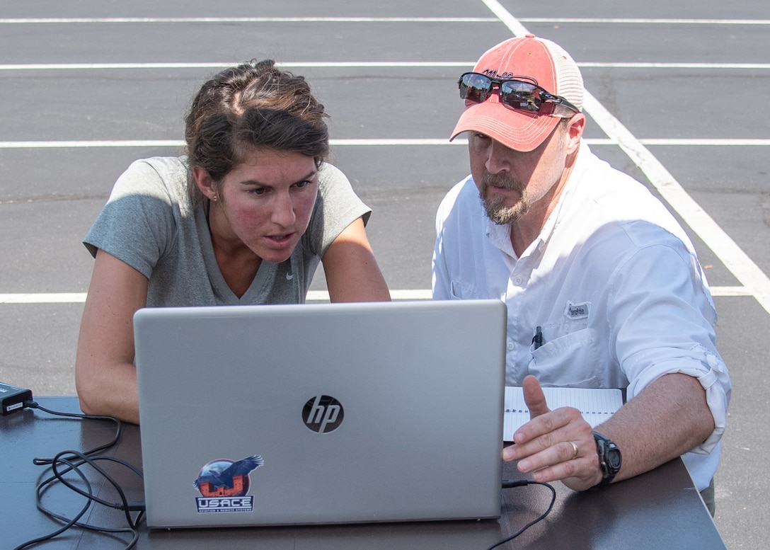Bethanie Thomas, left, a civil engineer with Huntsville Center’s Unmanned Aircraft Systems Site Development Branch, joins Ryan Strange, a research physical scientist with the U.S. Army Corps of Engineers’ Aviation and Remote Systems Program and Huntsville Center’s UAS Site Development Branch, to ensure an unmanned aircraft is following its prescribed flight plan Oct. 1, 2019, in Huntsville, Alabama.