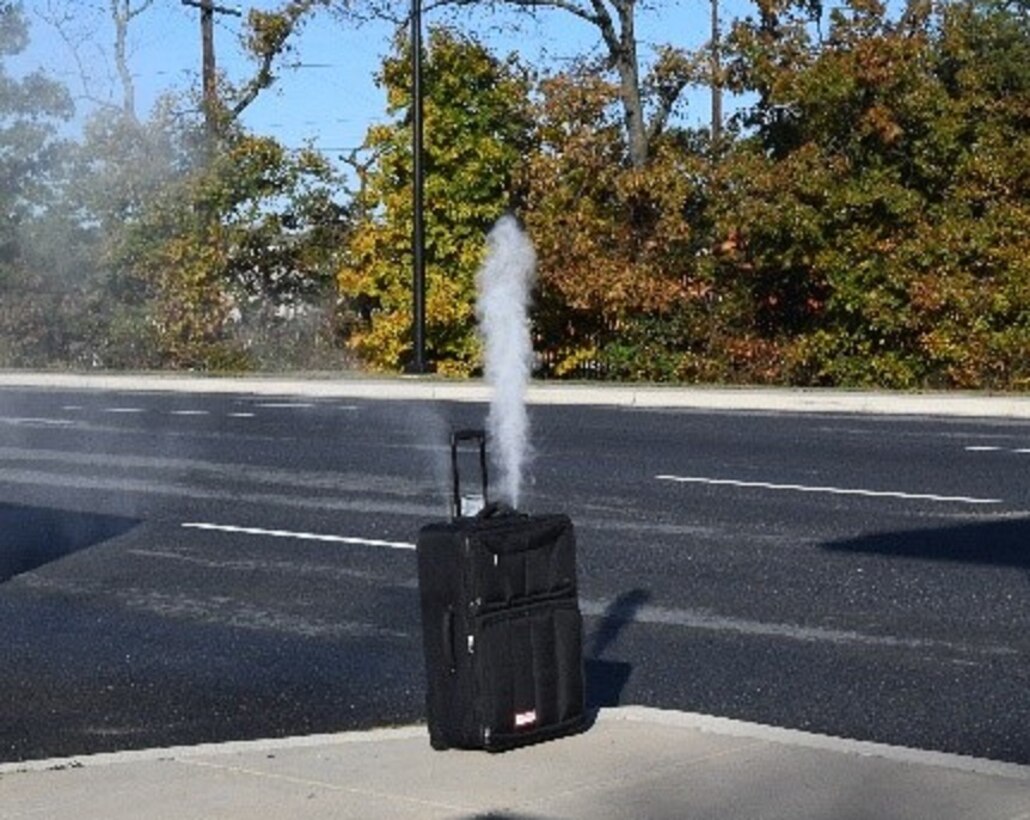 The exercise biological dispersal device, developed by Air Force Office of Special Investigations Special Agents Randy Flinchbaugh and Zeth Lackey of the 2nd Field Investigations Squadron, Joint Base Andrews, Md., detonates at the JBA Main Gate Oct. 23, 2019. (AFOSI photo)