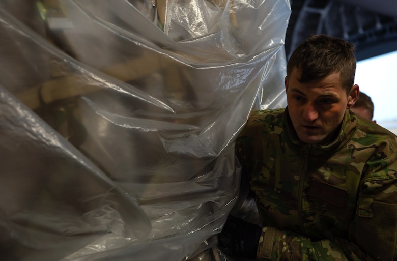 U.S. Air Force Staff Sgt. Garrett Sicafoose, 8th Airlift Squadron loadmaster, pushes a pallet of rice onto a C-17 Globemaster III assigned to the 62nd Airlift Wing, Joint Base Lewis-McChord, Wash., at Coronel Enrique Soto Cano Air Base, Honduras, Oct. 24, 2019. The rice was donated to Honduras as, due to extreme poverty and natural disasters, more than 48 percent of the population in rural areas are malnourished, with 35 percent overall. (U.S Air Force photo by Senior Airman Tryphena Mayhugh)