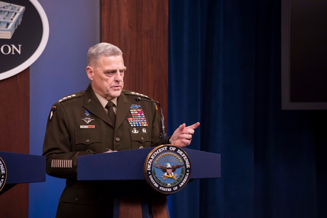 Four-star Army general answers a question while standing at a lectern bearing the Department of Defense emblem.