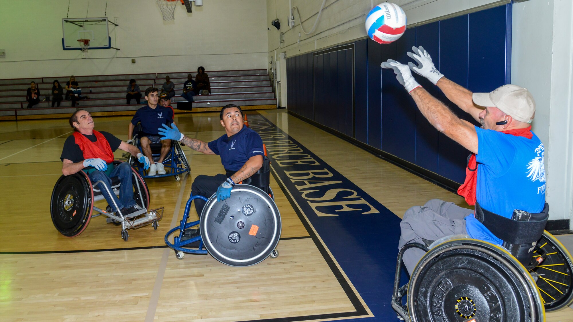 A player throws a ball back into play during a Murderball wheelchair rugby demonstration at Edwards Air Force Base, Oct. 24. The demonstration was headed by the Triumph Foundation, a non-profit organization, in support of the base's observance of National Disability Employment Awareness Month. (U.S. Air Force photo by Giancarlo Casem)