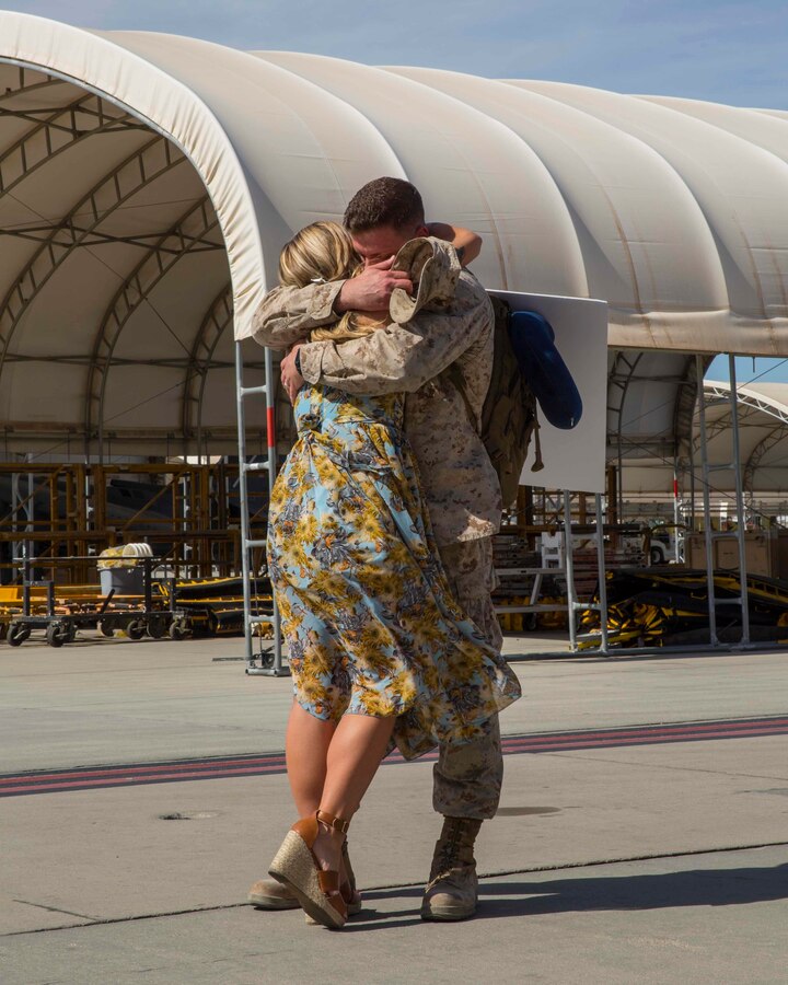 U.S. Marine 1st Lt. Andrew Bartek, the assistant supply officer for Marine Attack Squadron (VMA) 311, Marine Aircraft Group (MAG) 13, 3rd Marine Aircraft Wing (MAW), embraces his loved one on Marine Corps Air Station Yuma, Ariz., Oct. 27, 2019. The unit returned from a 6-month deployment to the Middle East. (U.S. Marine Corps photo by Lance Cpl. Jaime Reyes)