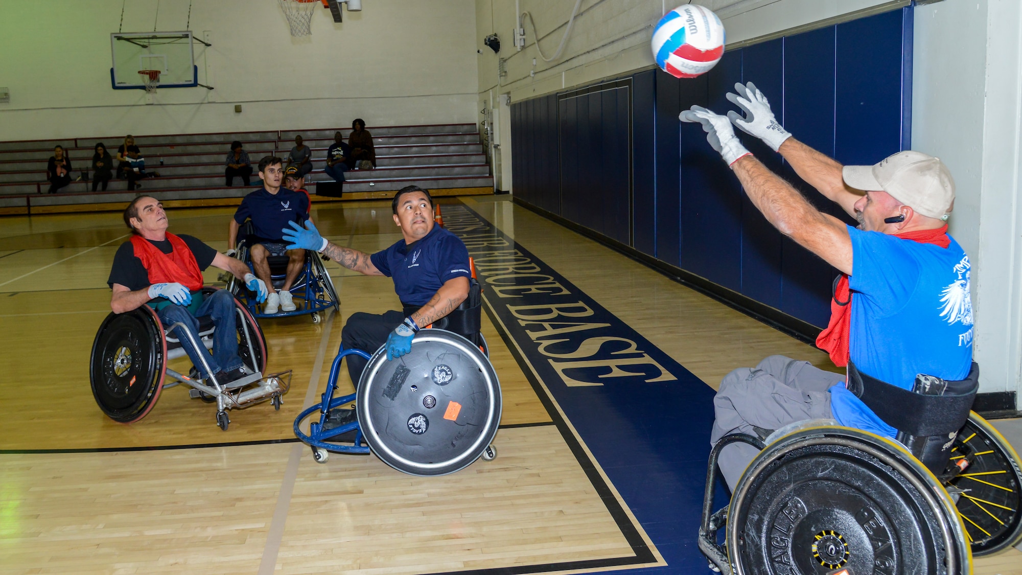 A player throws a ball back into play during a Murderball wheelchair rugby demonstration at Edwards Air Force Base, Oct. 24. The demonstration was headed by the Triumph Foundation, a non-profit organization, in support of the base's observance of National Disability Employment Awareness Month. (U.S. Air Force photo by Giancarlo Casem)
