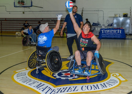 A wheelchair rugby game tips off at the base gym on Edwards Air Force Base, California, Oct. 24. The wheelchair rrugby, or murderball, demonstration was headed by the Triumph Foundation, a non-profit organization, in support of the base's observance of National Disability Employment Awareness Month. (U.S. Air Force photo by Giancarlo Casem)