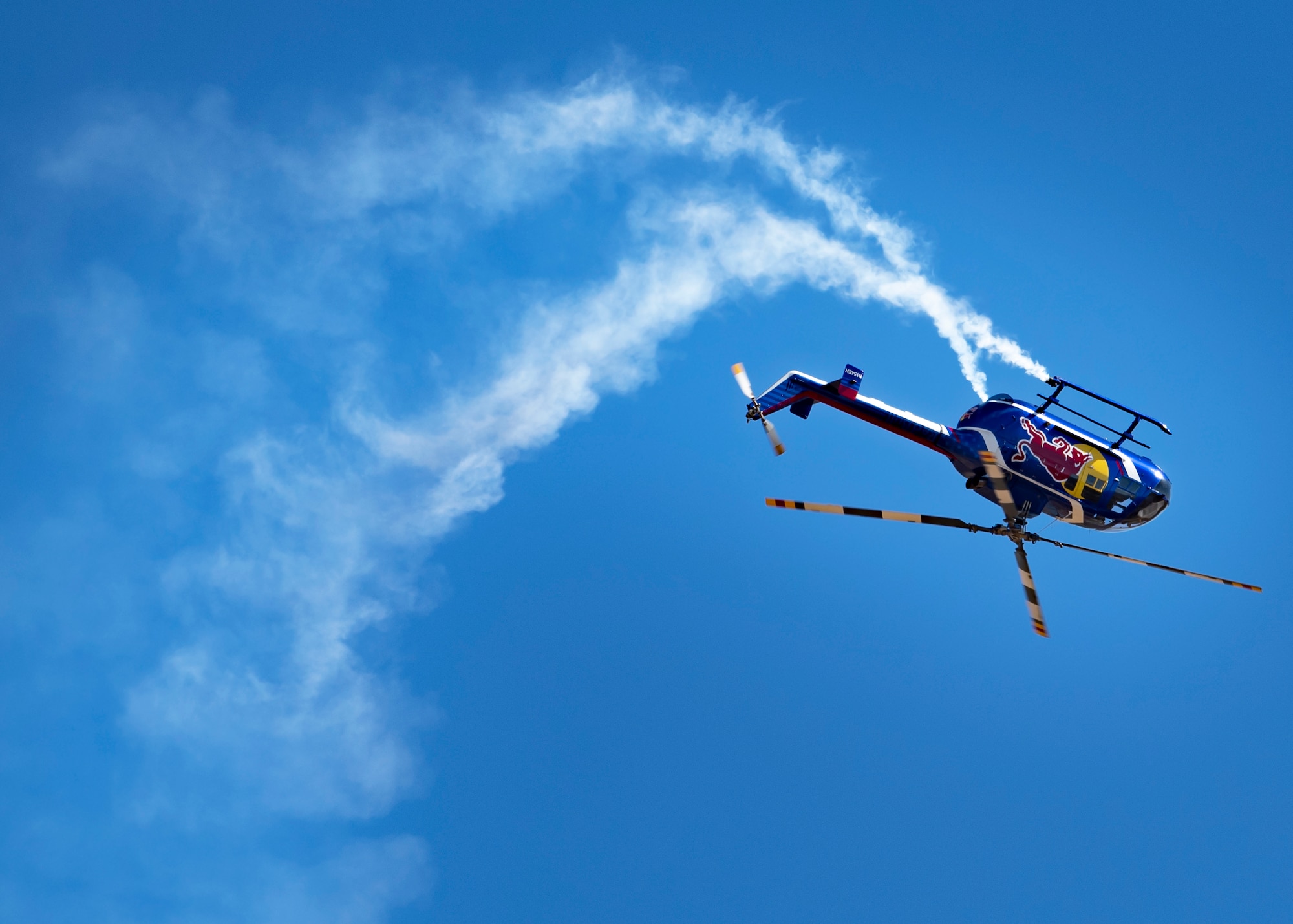 The Red Bull Air Force helicopter does a flip while performing at the Sheppard Air Force Base Guardians of Freedom Open House and Air Show at Sheppard AFB, Texas, Oct. 26, 2019. The Red Bull Air Force is a team assembled from accomplished and experienced aviation experts in the whole world. They specialize in highly coordinated aerial jump demonstrations and continually push the limits of human flight. They do base jumping, wingsuits, free flying, speed riding and more. (U.S. Air Force photo by Airman 1st Class Pedro Tenorio)