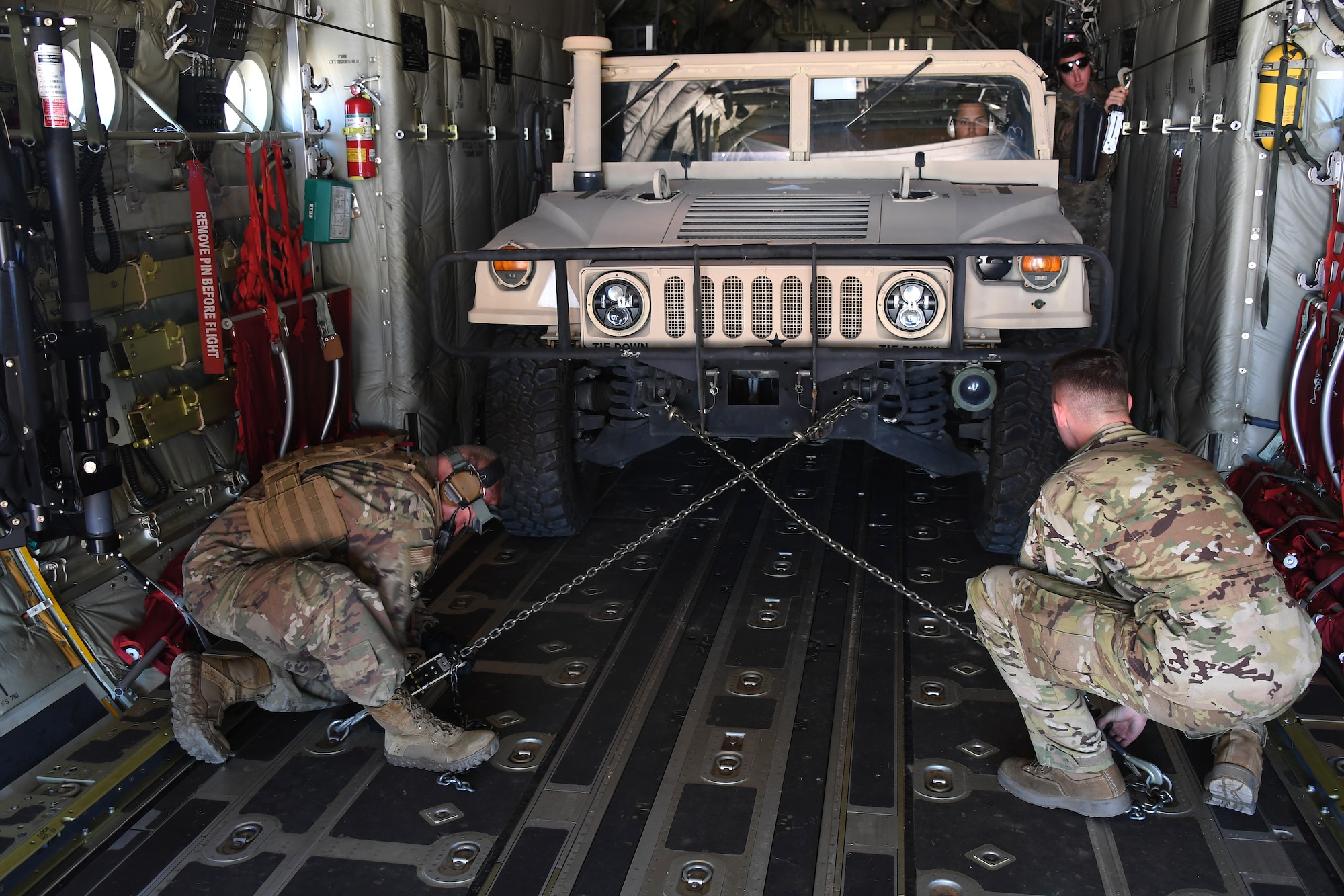 U.S. Air Force Airmen secure a Humvee onto a C-130 Hercules aircraft at the Geronimo Landing Zone during exercise Green Flag Little Rock, Oct. 23, 2019, Fort Polk, Louisiana. During the exercise the team loaded and downloaded tactical vehicles, airdrop bundles, along with a variety of other pallets to support the Army. (U.S. Air Force photo by Tech. Sgt. Liliana Moreno)