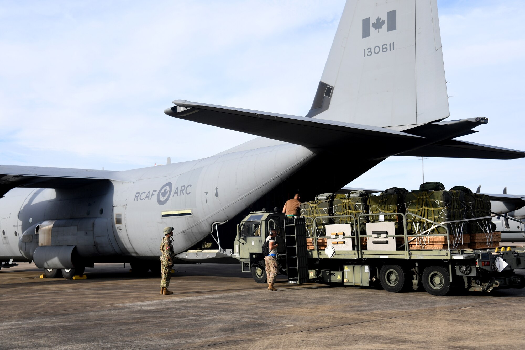 U.S. Air Force aerial porters from the 621st Contingency Response Group load cargo onto a Royal Canadian Air Force C-130 aircraft during exercise Green Flag Little Rock, Oct. 24, 2019, Alexandria International Airport, Louisiana. During the exercise the team loaded and downloaded tactical vehicles, airdrop bundles, along with a variety of other pallets to support the Army. (U.S. Air Force photo by Tech. Sgt. Liliana Moreno)