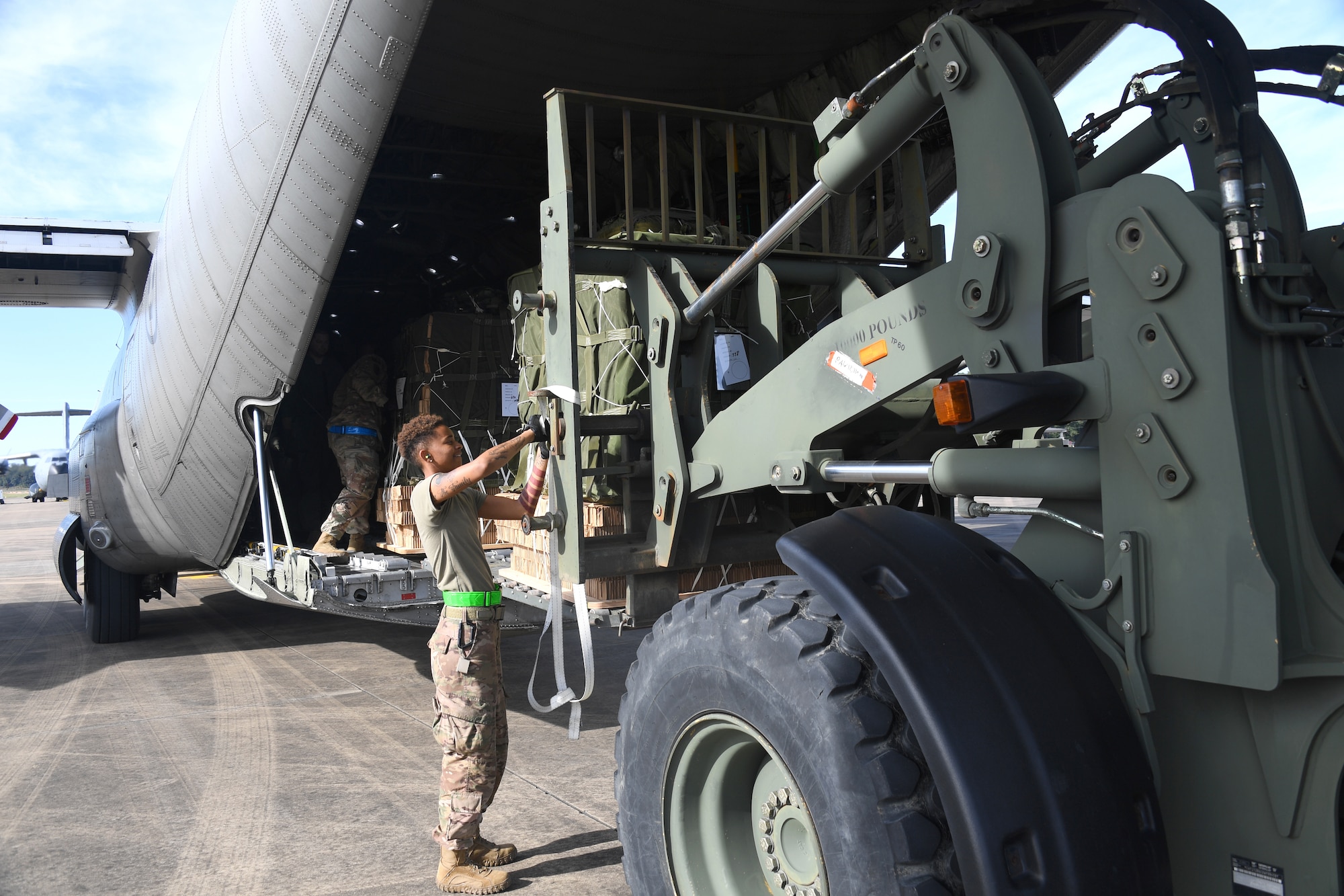 U.S. Air Force Airman 1st Class Dominitrius Stribling, 321st Contingency Response Squadron aerial porter, secures cargo being loaded onto a Swedish Air Force C-130 aircraft during exercise Green Flag Little Rock, Oct. 24, 2019, Alexandria International Airport, Louisiana. During the exercise the team loaded and downloaded tactical vehicles, airdrop bundles, along with a variety of other pallets to support the Army. (U.S. Air Force photo by Tech. Sgt. Liliana Moreno)