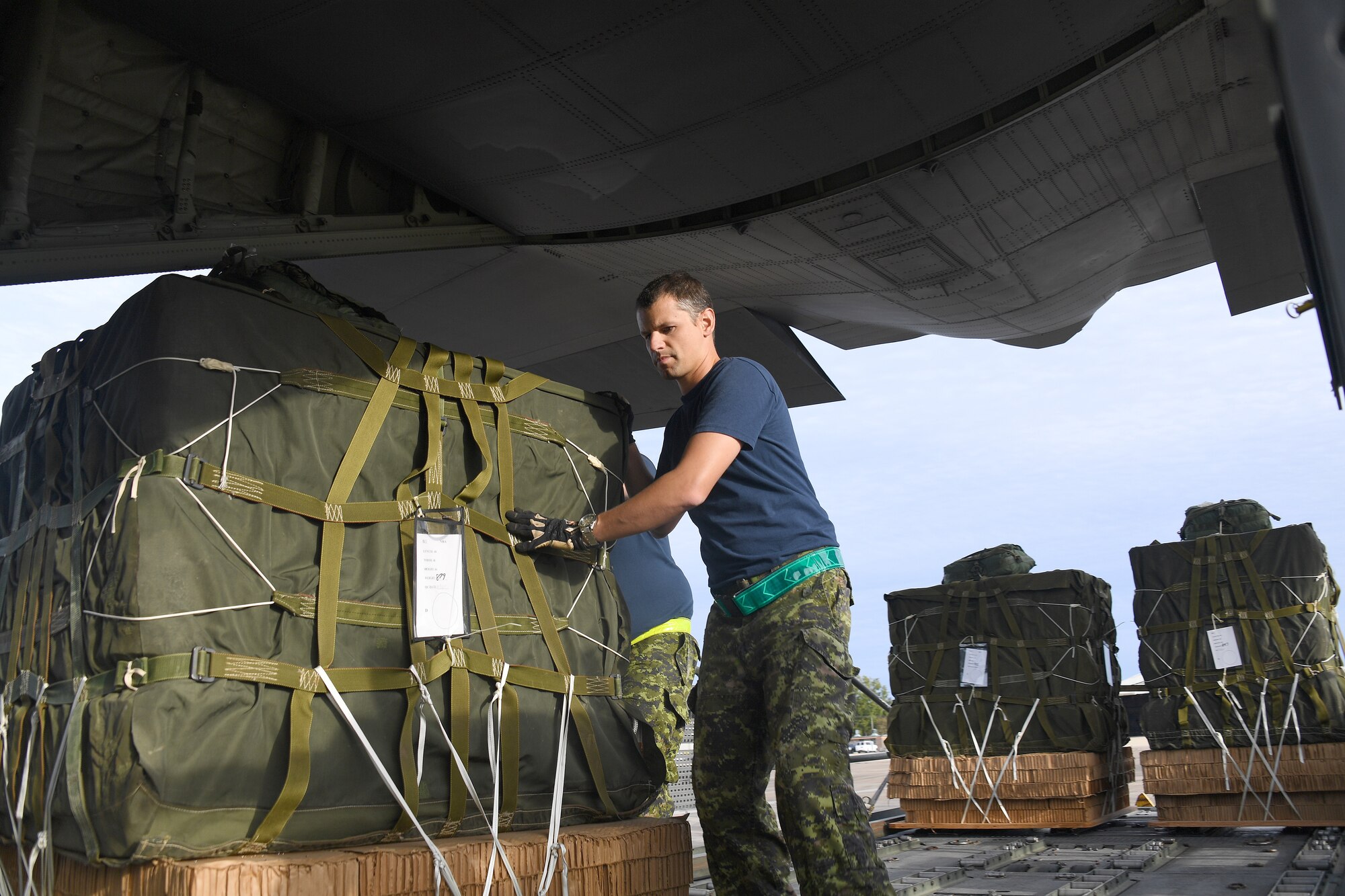 Royal Canadian Air Force loadmasters push cargo onto a C-130 aircraft during exercise Green Flag Little Rock, Oct. 24, 2019, Alexandria International Airport, Louisiana. The exercise also gave Airmen a unique opportunity to enhance partnerships with joint and allied partners. (U.S. Air Force photo by Tech. Sgt. Liliana Moreno)