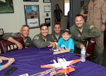 Corpus Christi, Texas Driscoll Children's Hospital patient, and Naval Air Station Corpus Christi Pilot for a Day Alessandra "Ale" Alaniz poses for a "hero" shot with her new Laughlin Air Force Base, Texas, aviation teammates (left to right) Lt. Col. Doug Hayes, 96th Flying Training Squadron; Capt. Roland Kern, 86th Flying Training Squadron; Capt. Anthony Giebelhaus, 86th FTS, and Maj. Wade Dahlgren, 96th FTS.  Ale is the 100th child selected for the NAS Corpus Christi program. (U.S. Air Force photo)