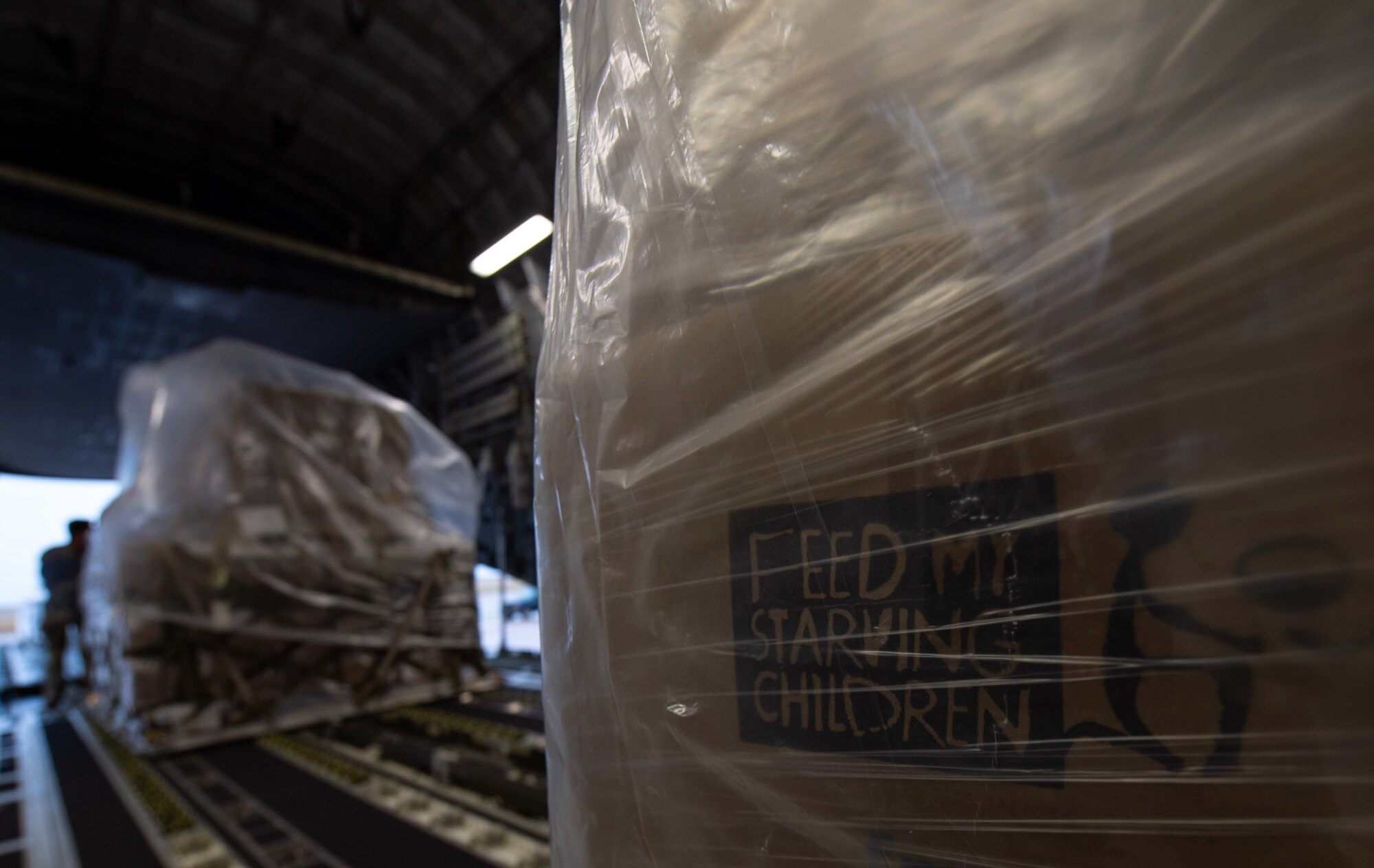 Airmen assigned to the 8th Airlift Squadron push a pallet of rice onto a C-17 Globemaster III assigned to the 62nd Airlift Wing, Joint Base Lewis-McChord, Wash., at Altus Air Force Base, Okla., Oct. 24, 2019. The rice was delivered to Honduras to feed more than 500,000 malnourished Honduran men, women and children. (U.S Air Force photo by Senior Airman Tryphena Mayhugh)