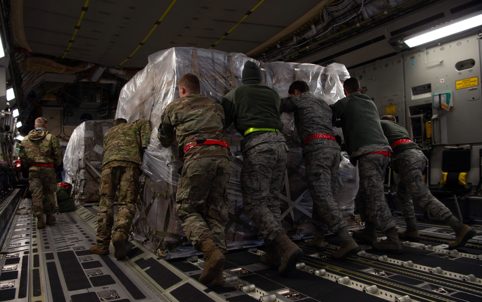 Airmen assigned to the 62nd Airlift Wing (AW) and 97th Air Mobility Wing load pallets of rice onto a C-17 Globemaster III assigned to the 62nd AW, Joint Base Lewis-McChord, Wash., at Altus Air Force Base, Okla., Oct. 24, 2019. More than 83,000 pounds of rice was delivered to Honduras by Airmen assigned to the 8th Airlift Squadron, Joint Base Lewis-McChord, Wash., for a humanitarian mission. (U.S Air Force photo by Senior Airman Tryphena Mayhugh)