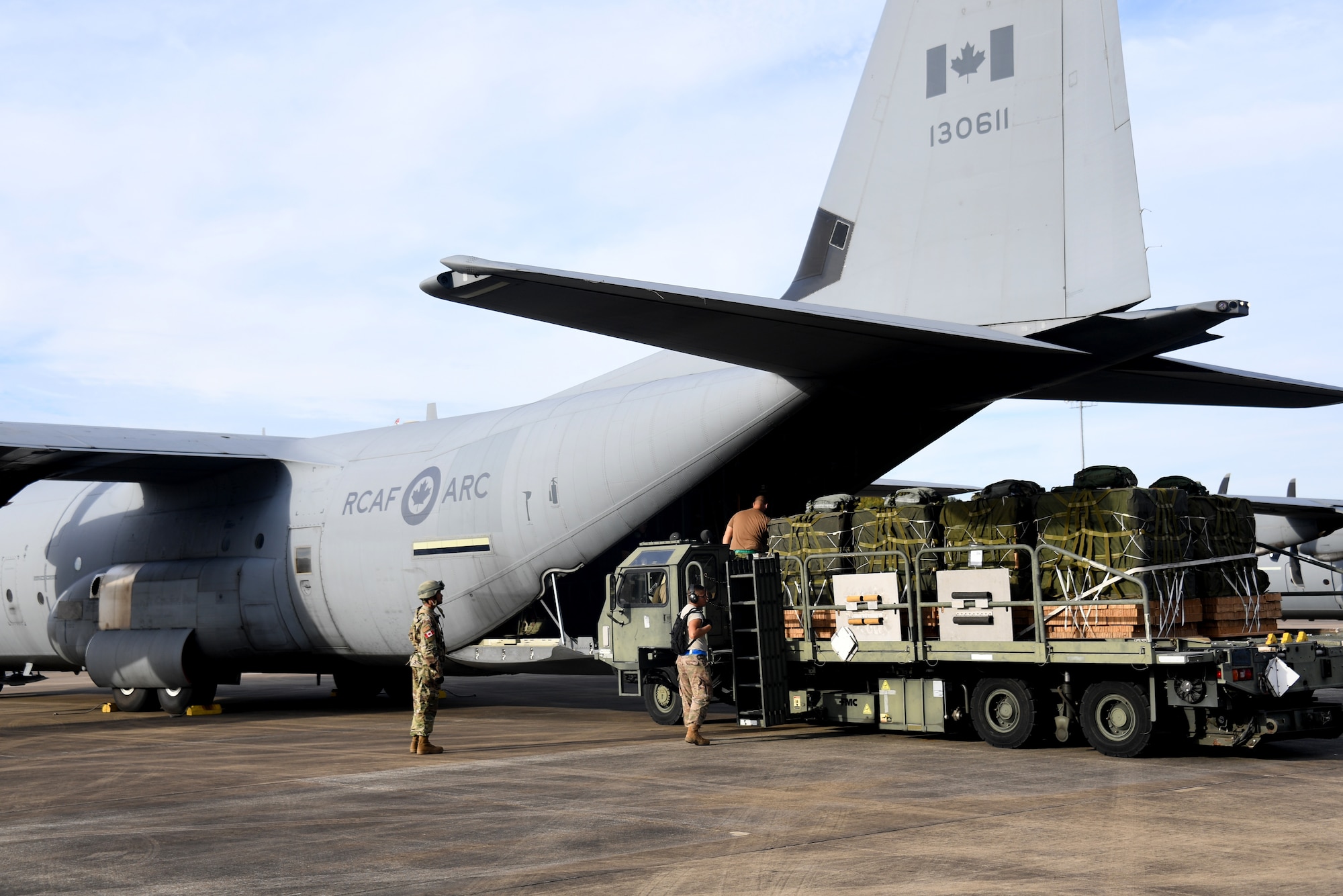 U.S. Air Force aerial porters from the 621st Contingency Response Group load cargo onto a Royal Canadian Air Force C-130 aircraft during exercise Green Flag Little Rock, Oct. 24, 2019, Alexandria International Airport, Louisiana. During the exercise the team loaded and downloaded tactical vehicles, airdrop bundles, along with a variety of other pallets to support the Army. (U.S. Air Force photo by Tech. Sgt. Liliana Moreno)