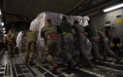 Airmen assigned to the 62nd Airlift Wing (AW) and 97th Air Mobility Wing load pallets of rice onto a C-17 Globemaster III assigned to the 62nd AW, Joint Base Lewis-McChord, Wash., at Altus Air Force Base, Okla., Oct. 24, 2019. More than 83,000 pounds of rice was delivered to Honduras by Airmen assigned to the 8th Airlift Squadron, Joint Base Lewis-McChord, Wash., for a humanitarian mission. (U.S Air Force photo by Senior Airman Tryphena Mayhugh)
