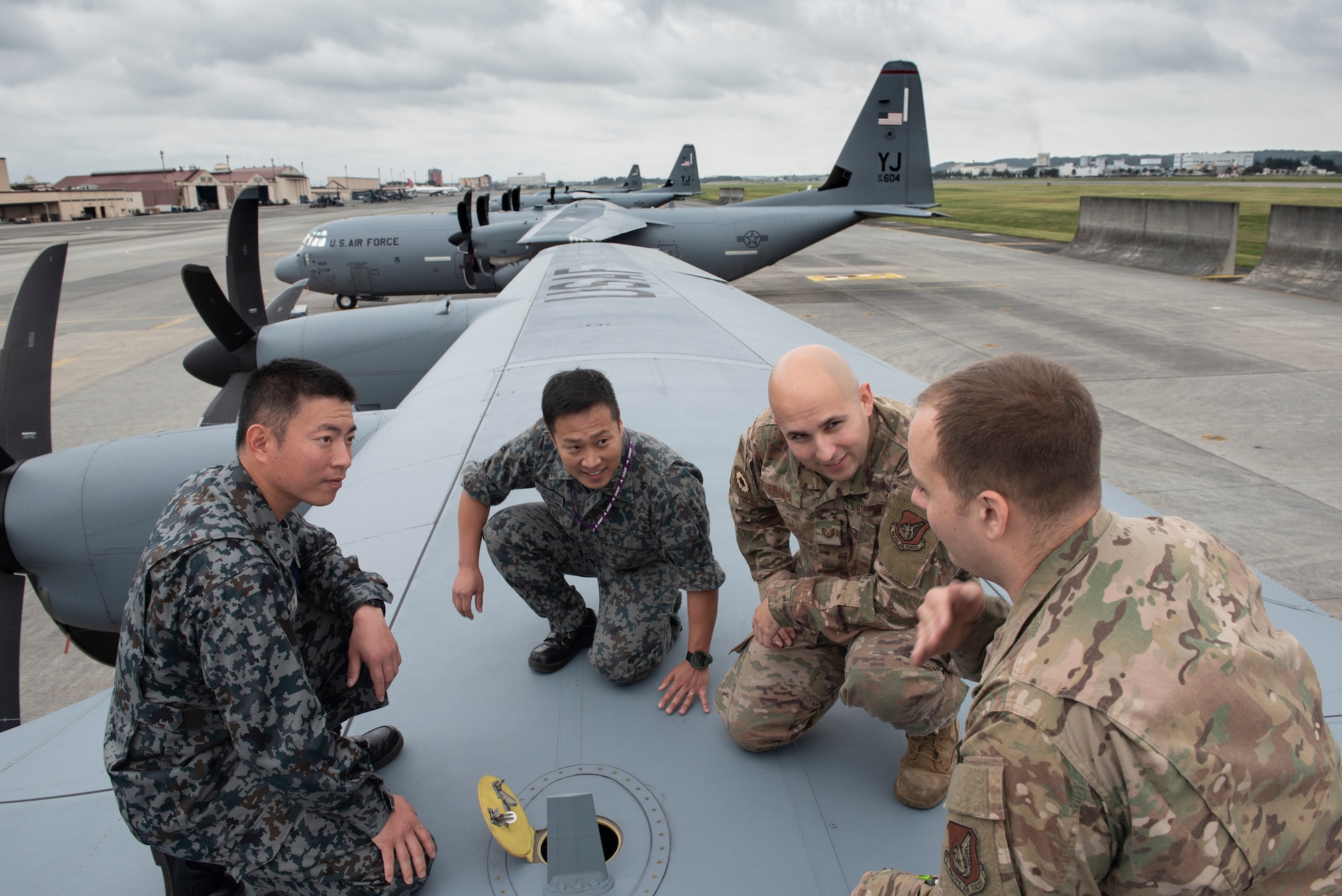 Staff Sgt. Joseph Crinite, 374th Aircraft Maintenance Squadron C-130J Hercules communication and navigation craftsman, shows a dry bay panel on top of a C-130J Super Hercules to members from the Japan Air Self-Defense Force during a Bilateral Exchange Program, Oct. 24, 2019, at Yokota Air Base, Japan.