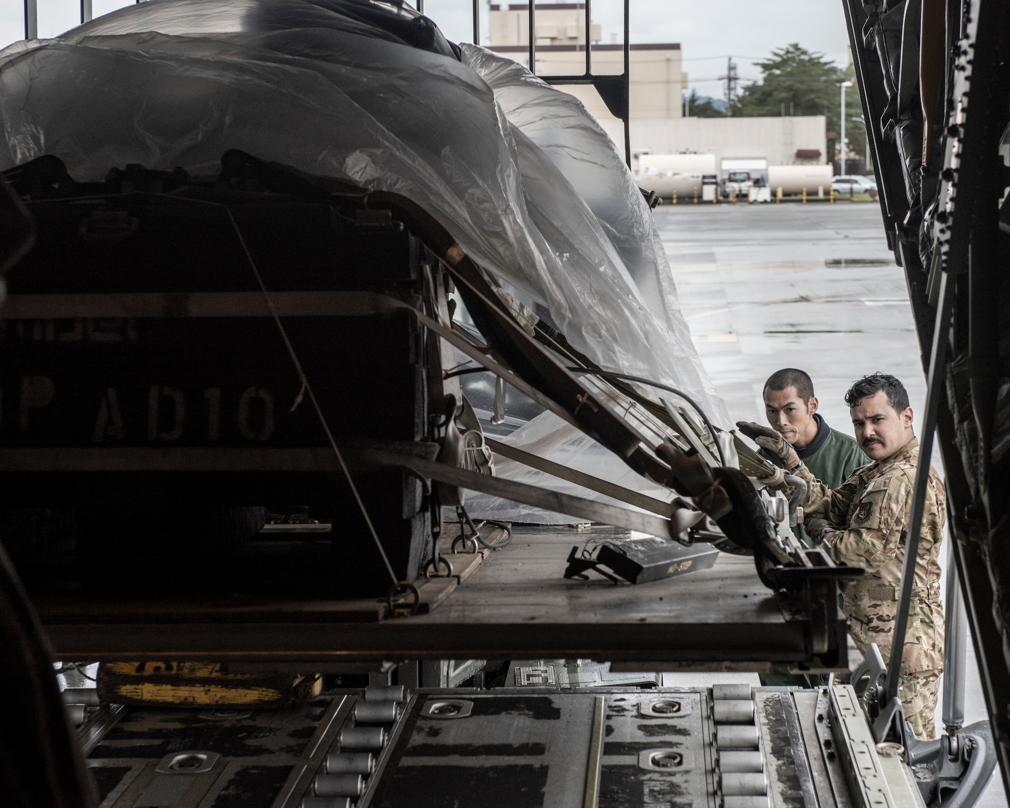 Staff Sgt. Hector Frietze, 36th Airlift Squadron loadmaster, marshals a forklift into a C-130J Super Hercules during a Bilateral Exchange Program, Oct. 22, 2019, at Yokota Air Base, Japan.
