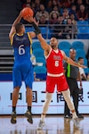 Air Force Staff Sgt. Jahmal Lawson contests a Brazilian competitor's jump shot during the CISM Military World Games in Wuhan, China, Oct. 25, 2019. The U.S. team defeated Brazil 78-61 to advance to the gold medal game. Lithuania earned the men’s basketball gold medal, and the U.S. team earned silver.