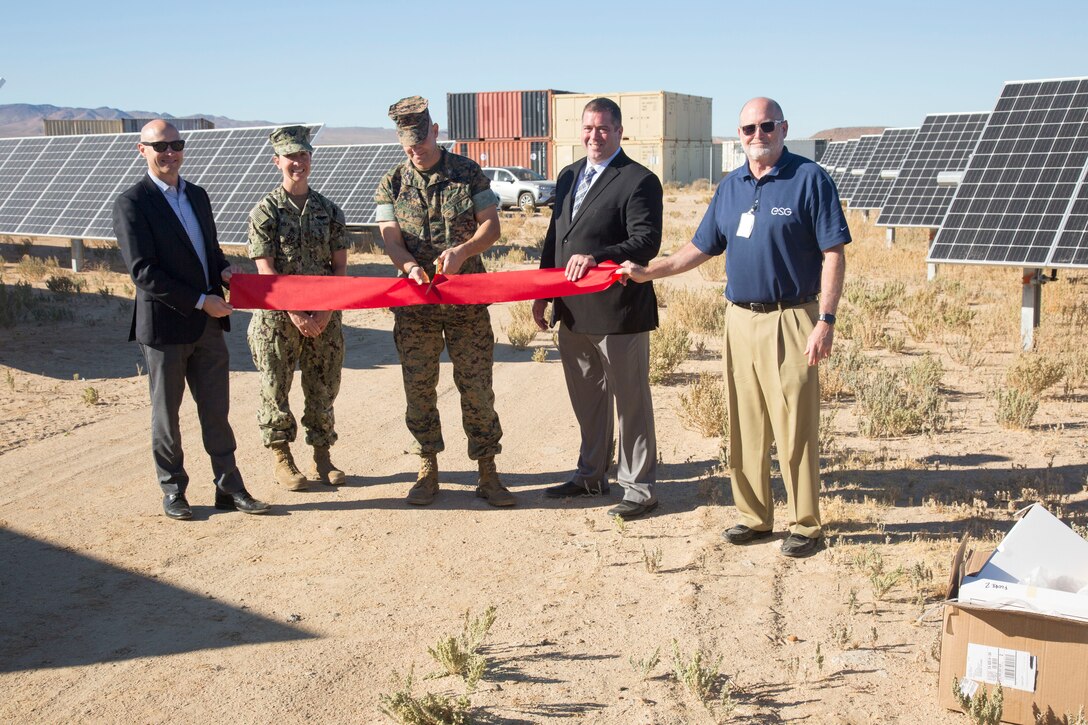 (Left) David Base, Energy Systems Group; Lt. Cmdr. Jamie Rivas, Public Works Officer, MCLB Barstow; Steven Smith, vice president, ESG; and David Koch ESG; join Col. Craig Clemans, commanding officer, MCLBB; as he officially opens a ten acre solar farm aboard the Yermo Annex of Marine Corps Logistics Base Barstow, Calif., Oct. 22.
