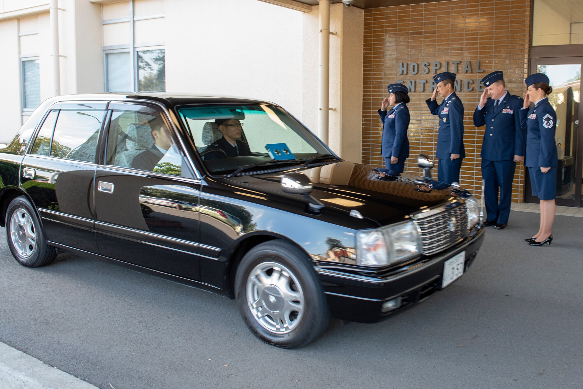 Leadership from Headquarters Pacific Air Forces and the 374th Medical Group salute the arrival of the car transporting Japanese Air Self-Defense Force Maj. Gen. Shinya Bekku, JASDF Surgeon General, upon his arrival to the 374th MDG at Yokota Air Base, Japan, Oct. 28, 2019.