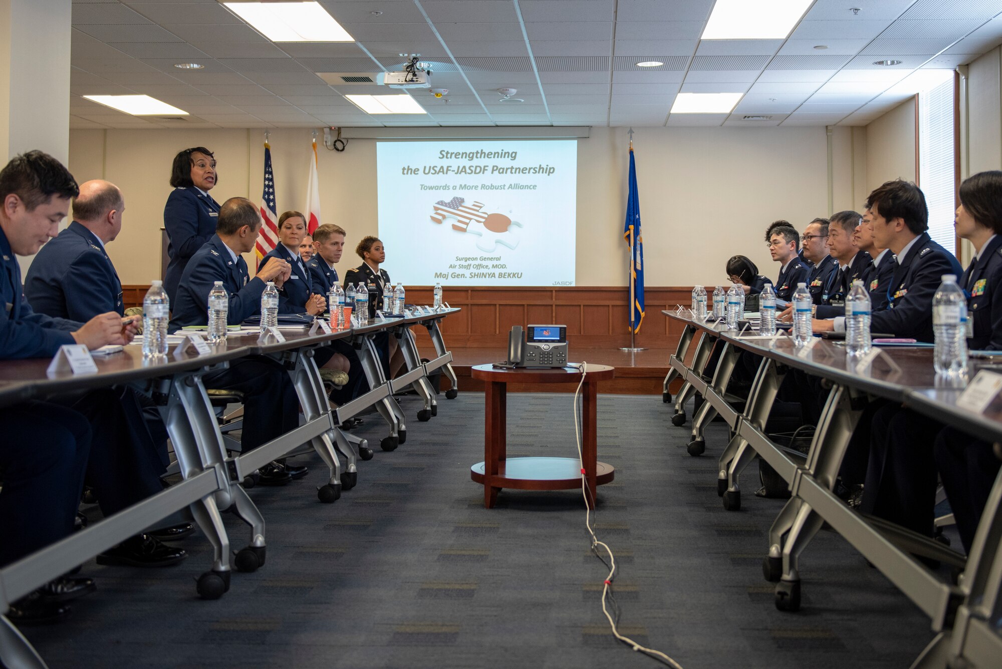 U.S. Air Force Col. Iris Reedom, United States Forces Japan Surgeon General and 374th Medical Group commander, welcomes Japanese Air Self-Defense Force Maj. Gen. Shinya Bekku, JASDF Surgeon General, and his team before beginning their meeting at Yokota Air Base, Japan, Oct. 28, 2019.