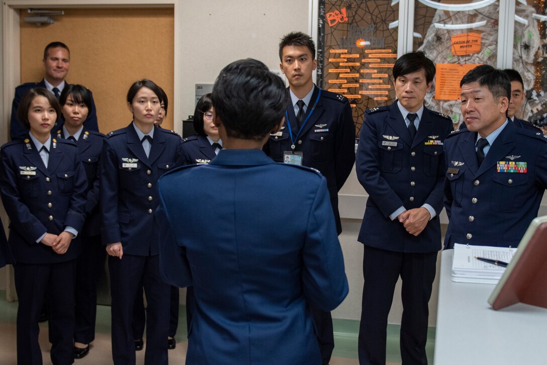 Japanese Air Self-Defense Force Maj. Gen. Shinya Bekku, JASDF Surgeon General, right, and his staff receive a briefing on the 374th Medical Group’s capability after meeting with the 374th MDG leadership at Yokota Air Base, Japan, Oct. 28, 2019.