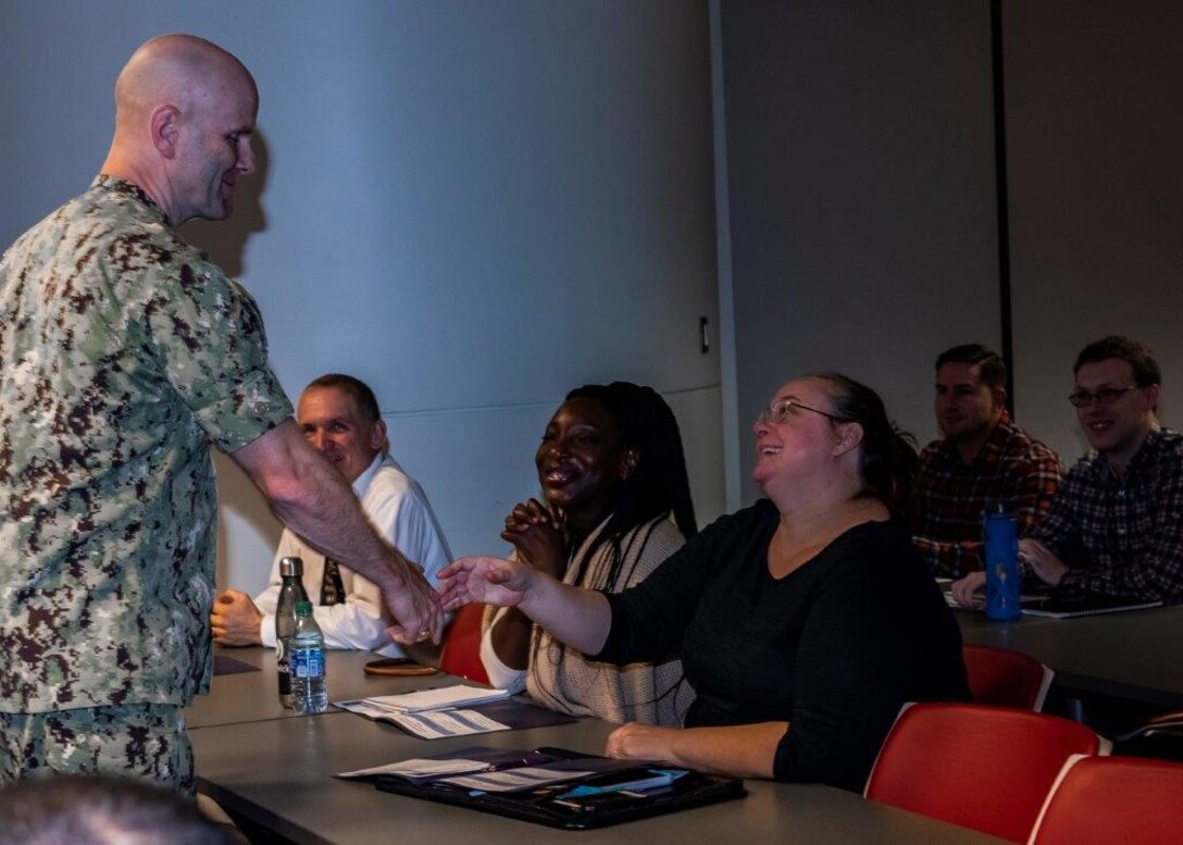 Rear Adm. Palmer Greets DLA Land & Maritime Academy Participants by shaking their hands at the Oct 22 event