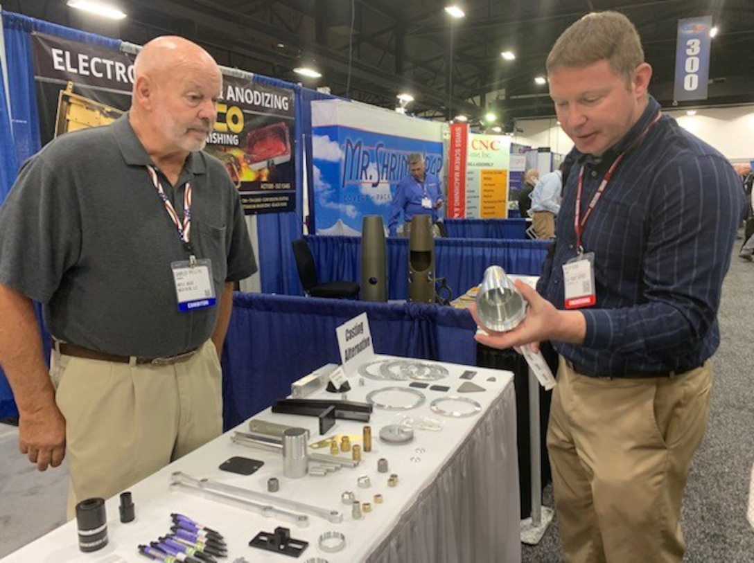 Phil Dicus, far right, DLA Troop Support Industrial Hardware employee speaks to a vendor at the Design-2-Part Show Oct. 23-24 in Oaks, Pennsylvania.