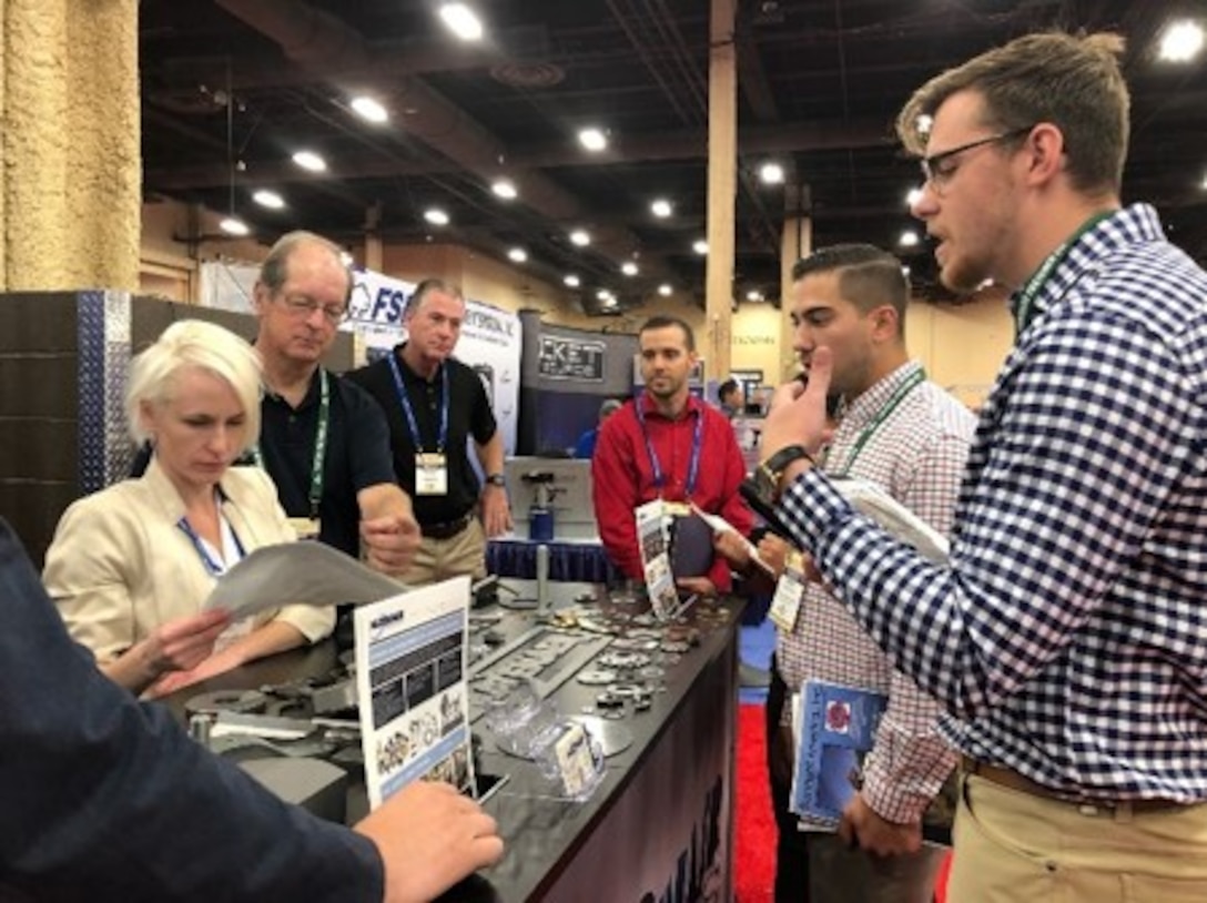 Alec Fixl, far right, DLA Troop Support Industrial Hardware employee speaks to vendors at the International Fastener Expo Sept. 29, 2019 in Las Vegas, Nevada.