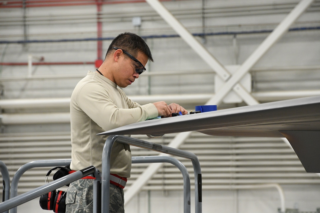 Tech. Sgt. Edmundo Pena, 388th Maintenance Squadron Fabrication Flight, performs a low observable restoration on a F-35A Lightning II wing tip at Hill Air Force Base, Utah, Oct. 3, 2019. The radar aborbent surface coatings on the F-35 help the aircraft survive in enemy air space. (U.S. Air Force photo by R. Nial Bradshaw)