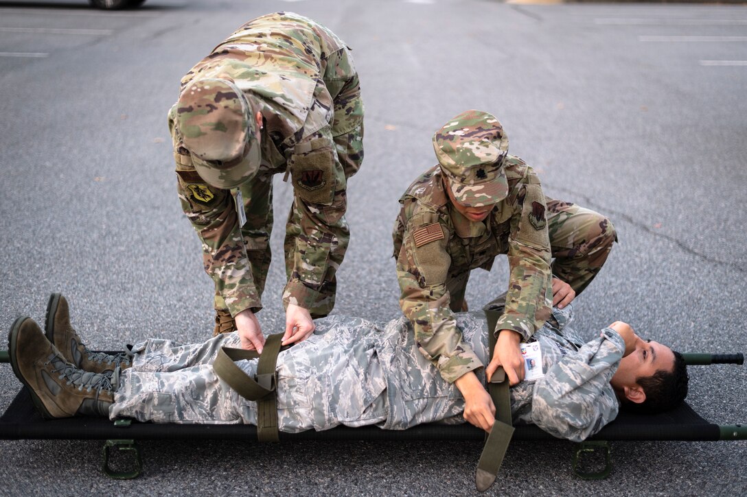 Airmen with the 23d Medical Group (MDG) secure a simulated patient during litter-carry training Oct. 25, 2019, at Moody Air Force Base, Ga. The 23d MDG conducted the training in preparation for the upcoming Thunder Over South Georgia Open House. Airmen practiced litter-carry movements and commands to ensure they have the appropriate skills in the case of an emergency. (U.S. Air Force photo by Airman 1st Class Taryn Butler)