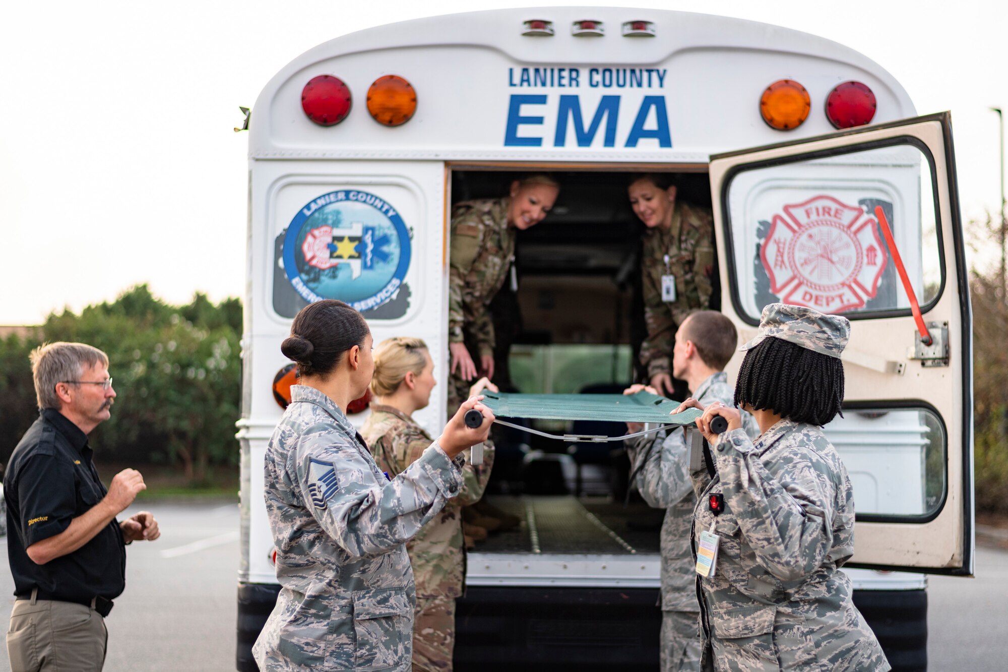 Airmen with the 23d Medical Group (MDG) load an ambulance bus during litter-carry training Oct. 25, 2019, at Moody Air Force Base, Ga. The 23d MDG conducted the training in preparation for the upcoming Thunder Over South Georgia Open House. Airmen practiced litter-carry movements and commands to ensure they have the appropriate skills in the case of an emergency. (U.S. Air Force photo by Airman 1st Class Taryn Butler)