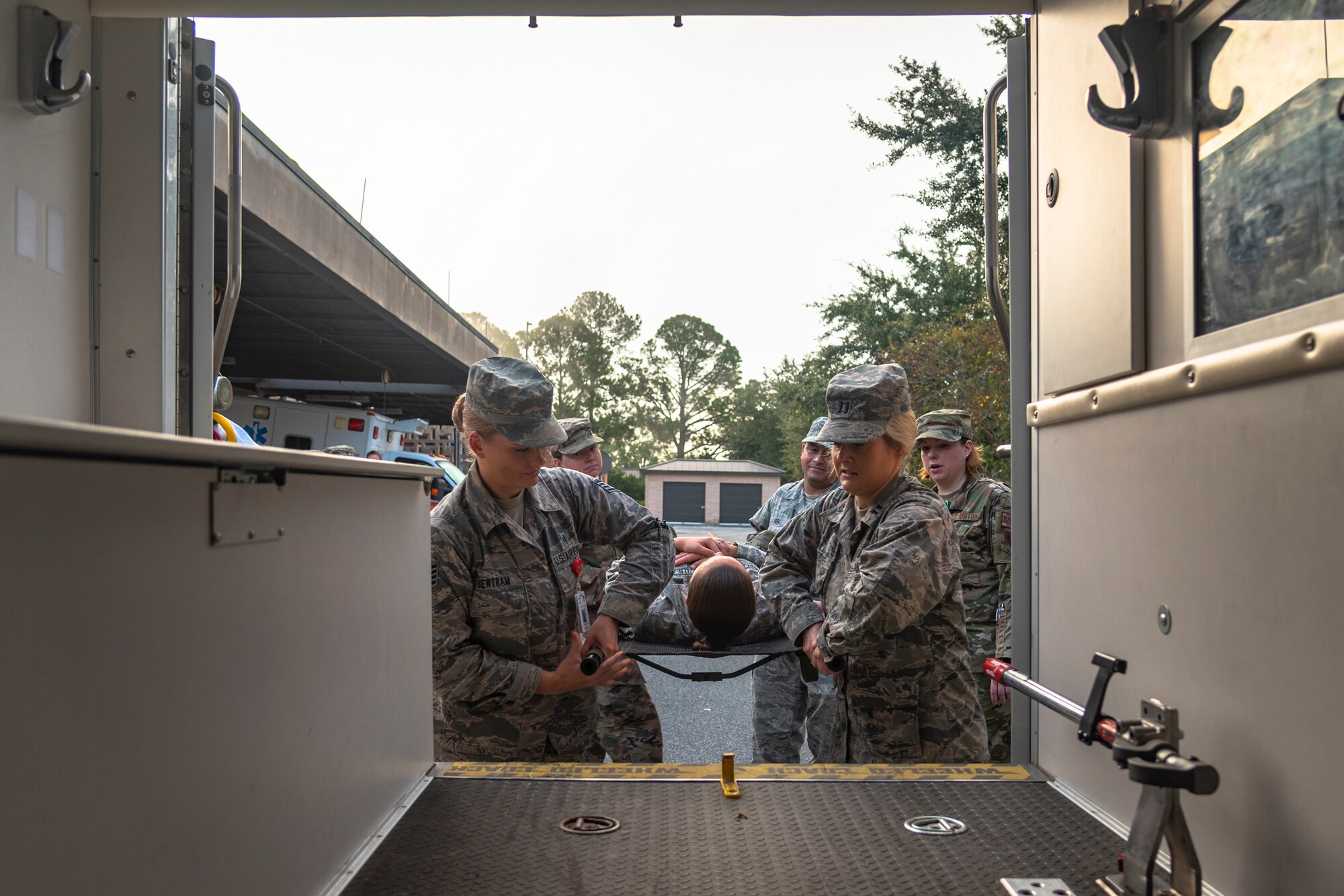 Airmen with the 23d Medical Group (MDG) place a simulated patient in an ambulance during litter-carry training Oct. 25, 2019, at Moody Air Force Base, Ga. The 23d MDG conducted the training in preparation for the upcoming Thunder Over South Georgia Open House. Airmen practiced litter-carry movements and commands to ensure they have the appropriate skills in the case of an emergency. (U.S. Air Force photo by Airman 1st Class Taryn Butler)