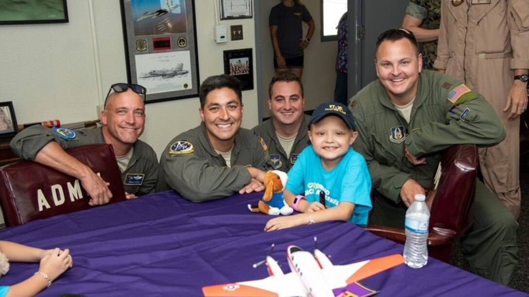 Driscoll Children's Hospital patient, and Naval Air Station Corpus Christi Pilot for a Day Alessandra "Ale" Alaniz poses for a "hero" shot with her new Laughlin Air Force Base, Texas, aviation teammates (left to right) Lt. Col. Doug Hayes, 96th Flying Training Squadron; Capt. Roland Kern, 86th Flying Training Squadron; Capt. Anthony Giebelhaus, 86th FTS, and Maj. Wade Dahlgren, 96th FTS.