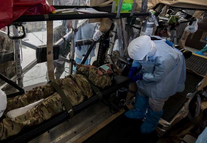 Staff Sgt. Lee Nembhard, an aeromedical evacuation technician assigned to the 375th Aeromedical Evacuation Squadron from Scott Air Force Base, Ill., fastens a litter to a Transport Isolation System during a TIS training exercise at Joint Base Charleston, S.C., October 23, 2019. The TIS is a device used to transport Ebola patients, either by C-17 Globemaster III or C-130 Hercules, while preventing the spread of disease to medical personnel and aircrews until the patient can get to one of three designated hospitals in the United States that can treat Ebola patients. JB Charleston is currently the only military installation with a TIS. The TIS mission is a sub-specialty of the aeromedical evacuation mission which requires frequent training to maintain readiness.