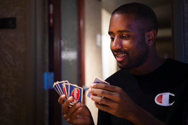 Senior Airman Justin McGee, 21st Operational Medical Readiness Squadron dental lab technician, plays a card game during Cyber Wednesday at Discovery Hall on Peterson Air Force Base, Colorado, Sept. 25, 2019. Regardless of station, all Airmen are invited to the 21st Space Wing hosted event. (U.S. Air Force photo by Airman 1st Class Jonathan Whitely)
