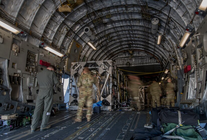 Flight nurses and critical care air transport team members assigned to the 43rd Aeromedical Evacuation Squadron from Pope Army Air Field, N.C., and 375th AES from Scott Air Force Base, Ill., prepare a Transport Isolation System for simulated Ebola patients during a TIS training exercise at Joint Base Charleston, S.C., October 23, 2019. The TIS is a device used to transport Ebola patients, either by C-17 Globemaster III or C-130 Hercules, while preventing the spread of disease to medical personnel and aircrews until the patient can get to one of three designated hospitals in the United States that can treat Ebola patients. JB Charleston is currently the only military installation with a TIS. The TIS mission is a sub-specialty of the aeromedical evacuation mission which requires frequent training to maintain readiness.