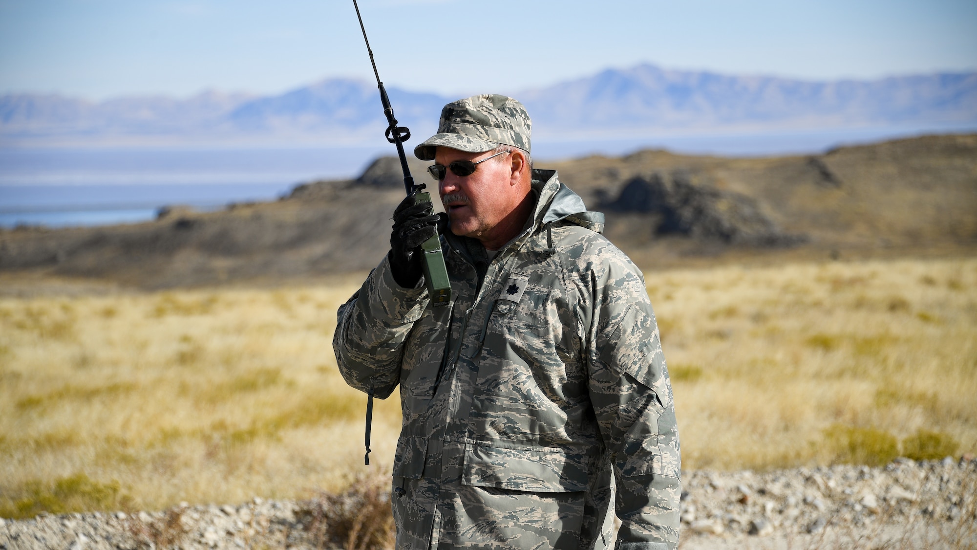 Lt. Col. Don Teig with the Reserve 757th Airlift Squadron communicates with an airbourne C-130 Hercules crew during an aerial spray operation at the Utah Test and Training Range on Oct. 24, 2019.