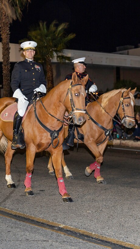 Colonel Craig C. Clemans (left), commanding officer of Marine Corps Logistics Base Barstow, and Sgt. Maj. Sergio MartinezRuiz, base sergeant major, ride in the Kiwanis Club's 87th annual Mardi Gras Parade in Barstow, Calif., Oct. 26. (U.S. Marine Corps photo by Jack J. Adamyk)