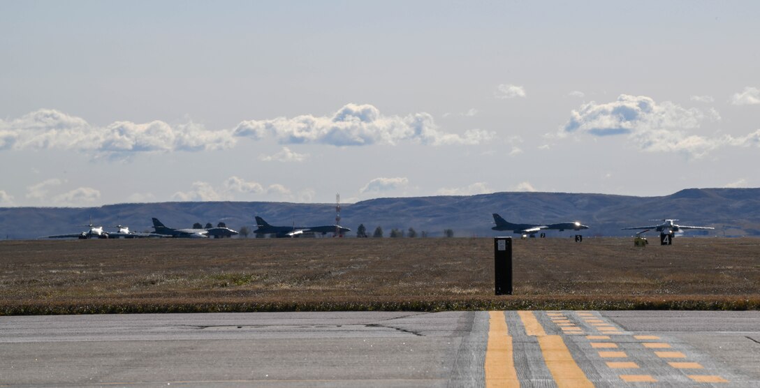 Six B-1B Lancers line up on the taxiway at Ellsworth Air Force Base, S.D., Oct. 24, 2019. Four of the B-1s launched to support a Bomber Task Force in U.S. Central Command’s area of operations. The unannounced arrival of the B-1 demonstrates the global strike capacity and ability of the U.S. Air Force and Air Force Global Strike Command to rapidly deploy forward and deliver precision-guided ordnance against any adversary. The United States routinely and visibly demonstrates to our allies and partners through the global employment of our military forces. (U.S. Air Force photo by Airman 1st Class Christina Bennett)