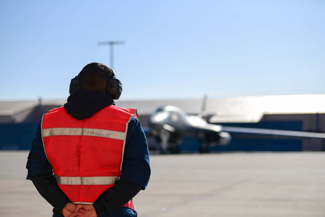 A 28th Bomb Wing maintenance crew chief waits for B-1B Lancers to taxi toward the runway at Ellsworth Air Force Base, S.D., Oct. 24, 2019. Several B-1s were scheduled to support a Bomber Task Force in the U.S. Central Command area of operations. The B-1 can rapidly deliver massive quantities of precision and non-precision weapons against any adversary. These bomber missions are representative of the United States’ commitment to our allies and enhancing regional security. (U.S. Air Force photo by Airman 1st Class John C.B. Ennis)