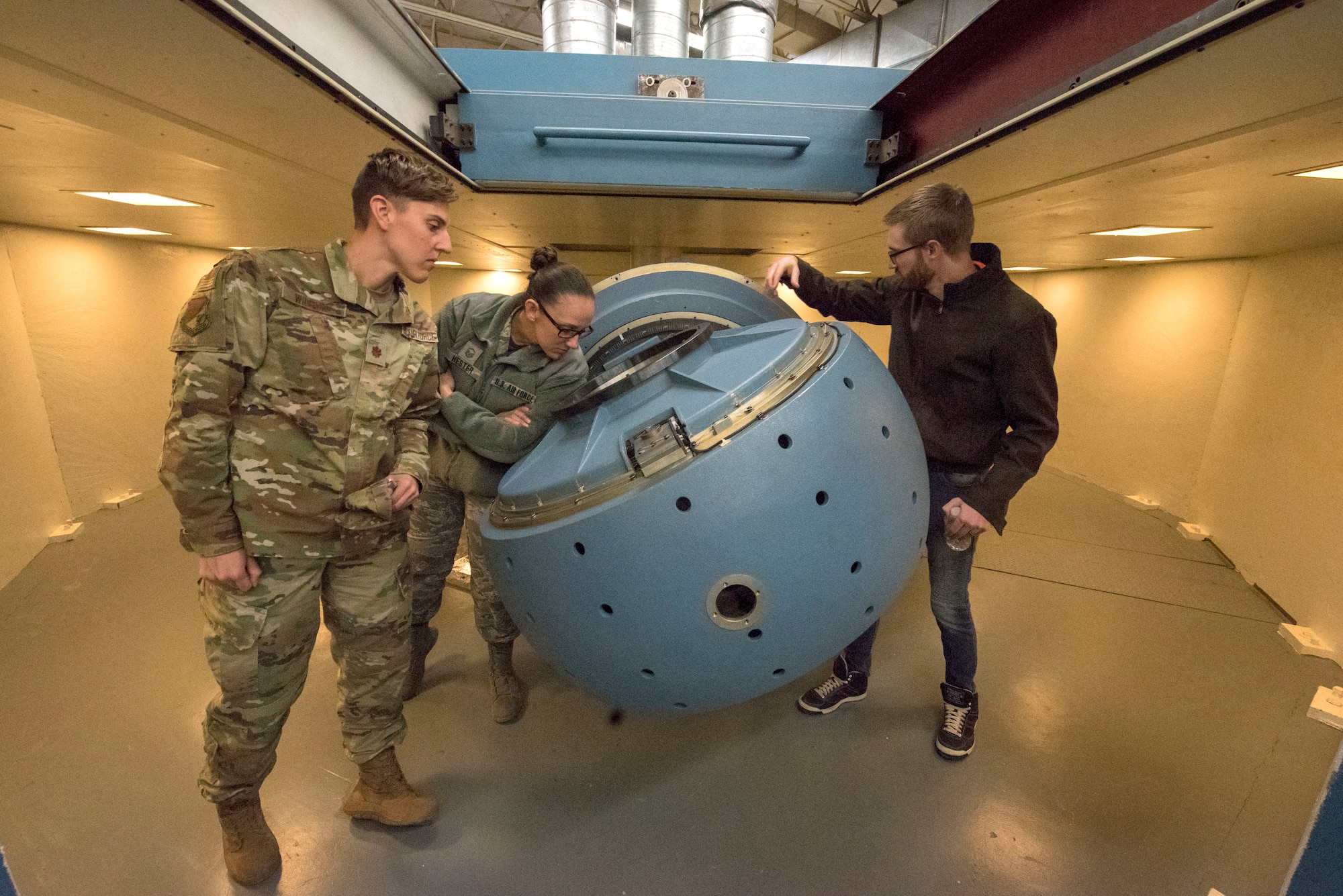 Sean Abrahamson, 746th Test Squadron test manager, shows event patrons a centrifuge used for testing, Oct. 25, 2019, on Holloman Air Force Base, N.M. The 746th TS centrifuge testing uses multi-axis test tables to check inertial performance on navigations systems prior to testing in aircraft. (U.S. Air Force photo by Staff Sgt. Christine Groening)