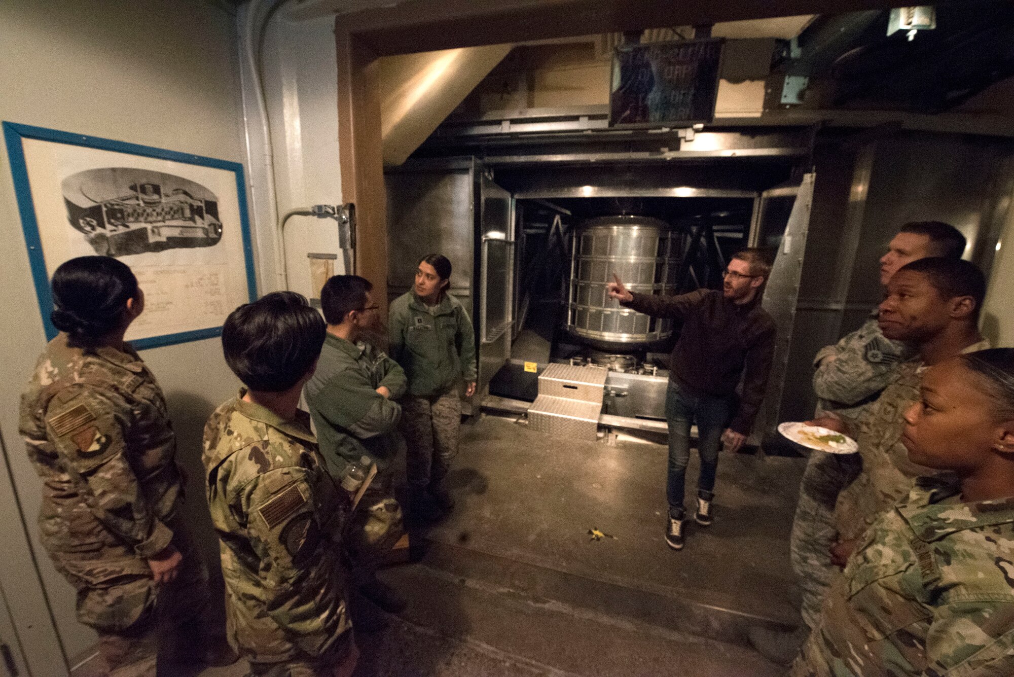 Sean Abrahamson, 746th Test Squadron test manager, gives guests a tour of the 746th TS facilities, Oct. 25, 2019, on Holloman Air Force Base, N.M. The test squadron provided facility tours featuring test equipment and hardware, an aircraft flyover and opened a time capsule from 1963 as part of their 60th anniversary celebration. (U.S. Air Force photo by Staff Sgt. Christine Groening)